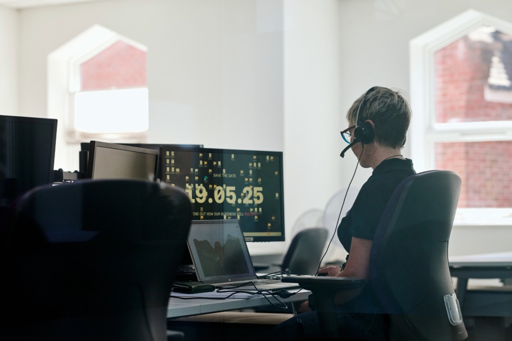 TXP worker on a computer in a well lit office